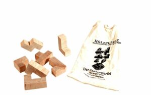 Der Zauberwürfel - Holz Knobelpuzzle im umweltfreundichen Packsack - 7 Teile